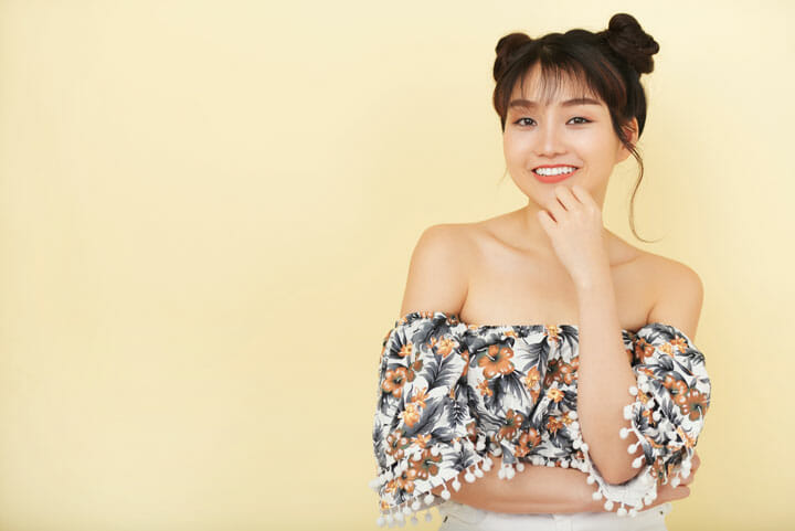 happy young Korean woman bare shoulder-top